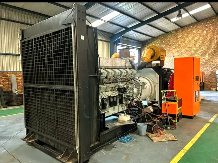 PowerFix engineer inspecting an industrial diesel generator inside a commercial facility in Lagos